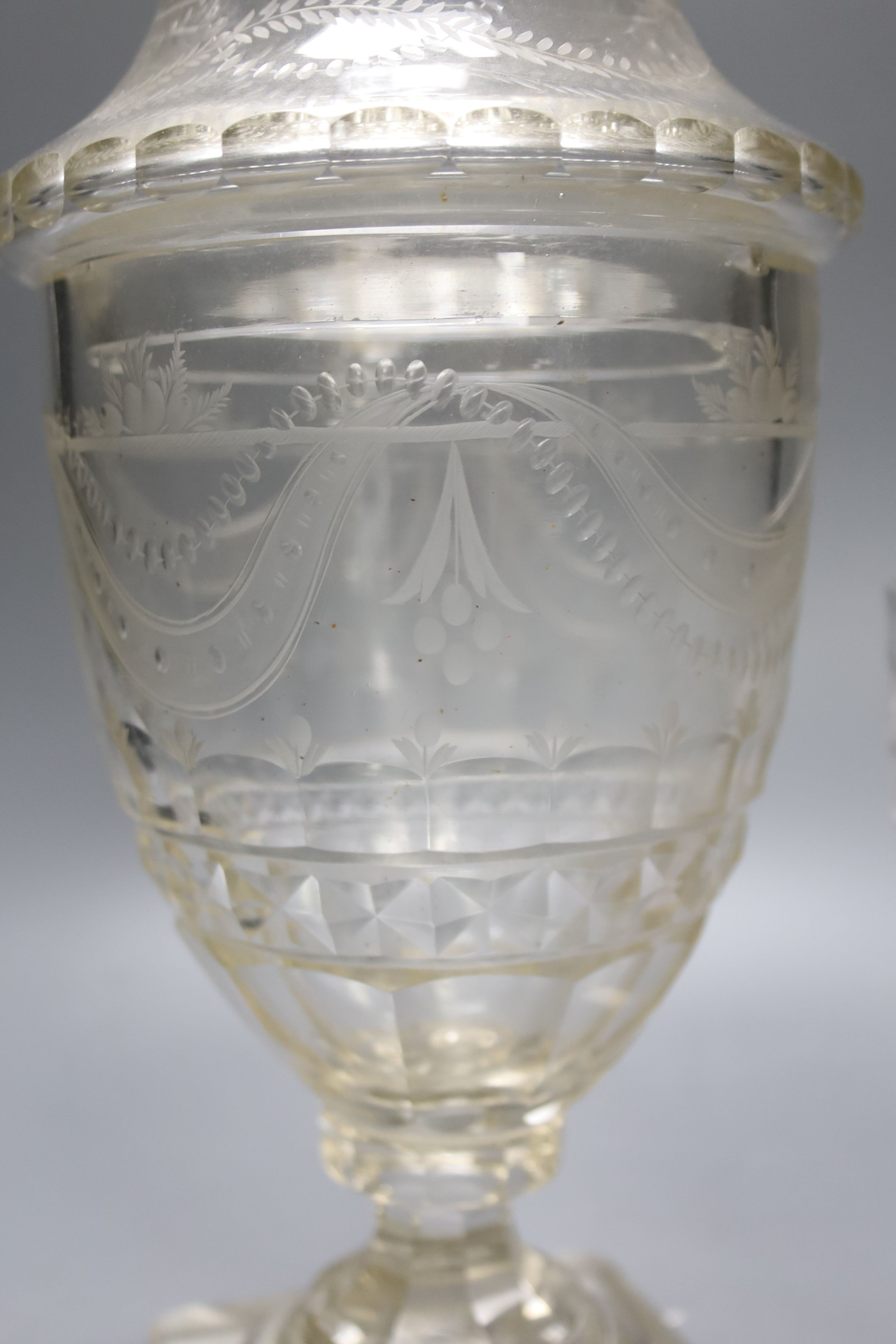 A Regency cut glass urn and cover and another urn